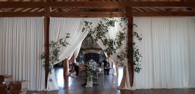 Ivory spandex drape in rustic wedding setting